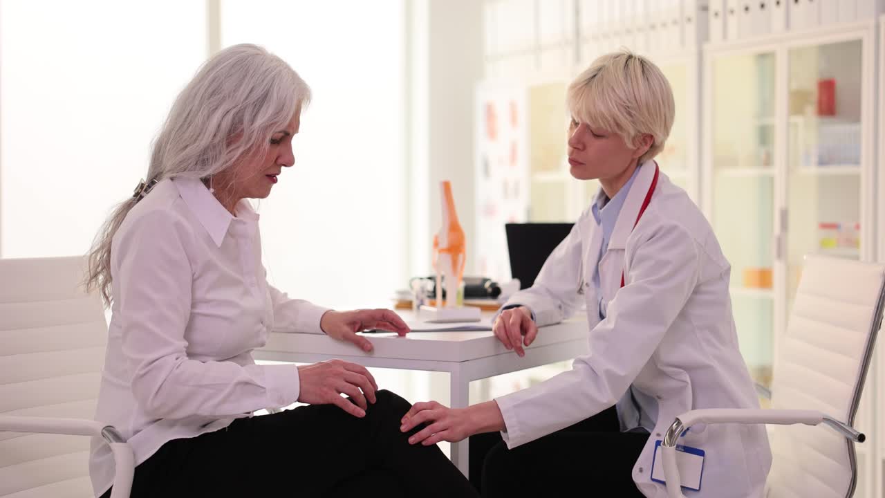 Doctor consulting with elderly patient in clinic
