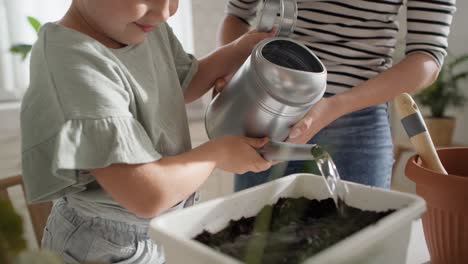 video of mother and daughter finishing home compost.