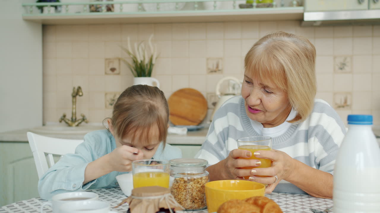 Grandmother and Granddaughter Enjoying Breakfast Together