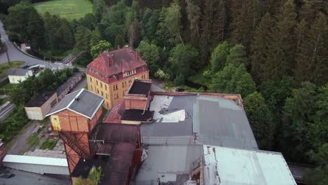 aerial view of a demolished roof of a socialist lost place factory in eastern germany filmed with drone viewing down