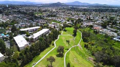 Aerial-back-pan-of-a-golf-course-surrounded-by-homes