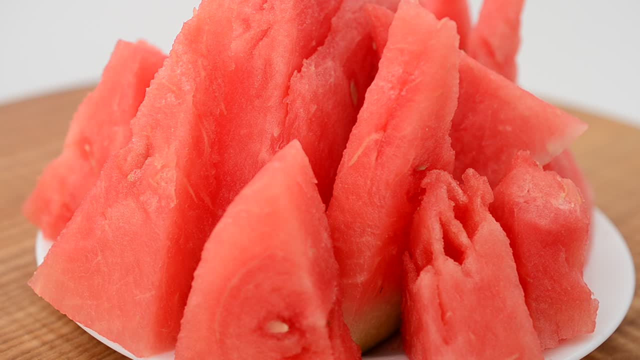 Shooting of a watermelon on a kitchen board. Shooting in the movement