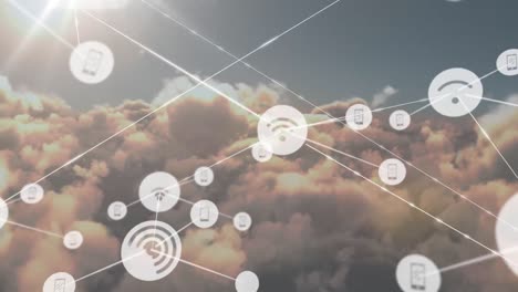 Animation-of-network-of-digital-icons-against-clouds-and-sun-in-the-sky