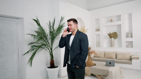 man wearing a jacket having phone conversation. friendly talk on the smartphone with lots of laughs.