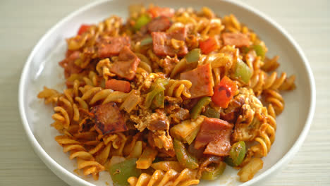 stir fried fusilli pasta with ham and tomatoes sauce