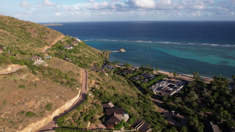 british virgin islands, drone shot of shoreline, roads, luxury beach tropical resort and coral reefs in caribbean sea