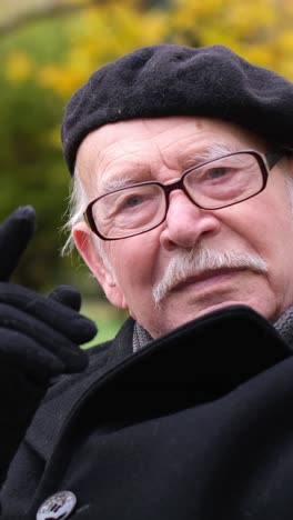 portrait of an older man wearing a beret and glasses