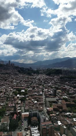 experience medellín, colombia, through an aerial view capturing its vibrant cityscape, surrounded by the majestic andes mountains and lush greenery. perfect for cultural and travel-focused projects.