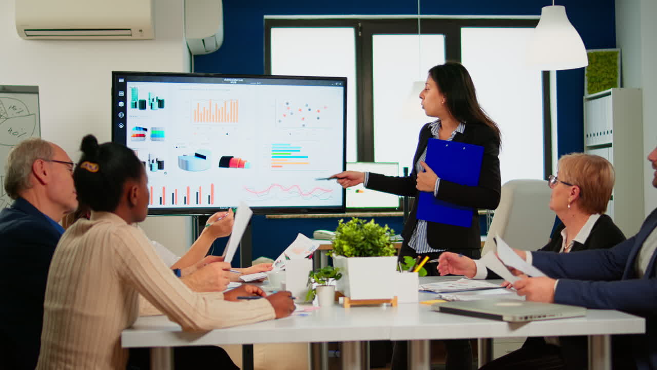 Female project manager holding financial meeting showing statistical graphs