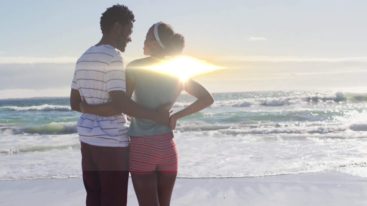 animación de senderos de luz sobre una pareja afroamericana en la playa