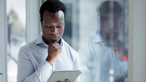Business-tablet,-typing-and-black-man-thinking