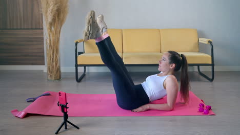 woman doing leg raises workout at home