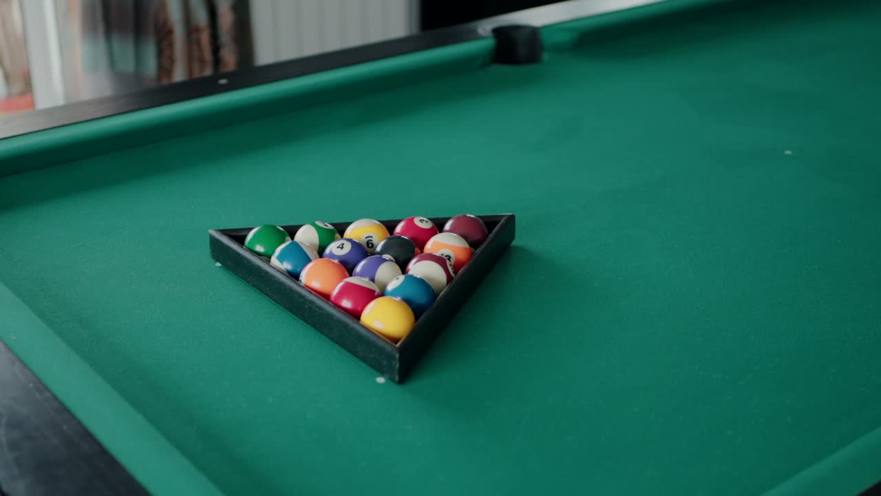 pool table with balls racked in a triangular formation, ready for play