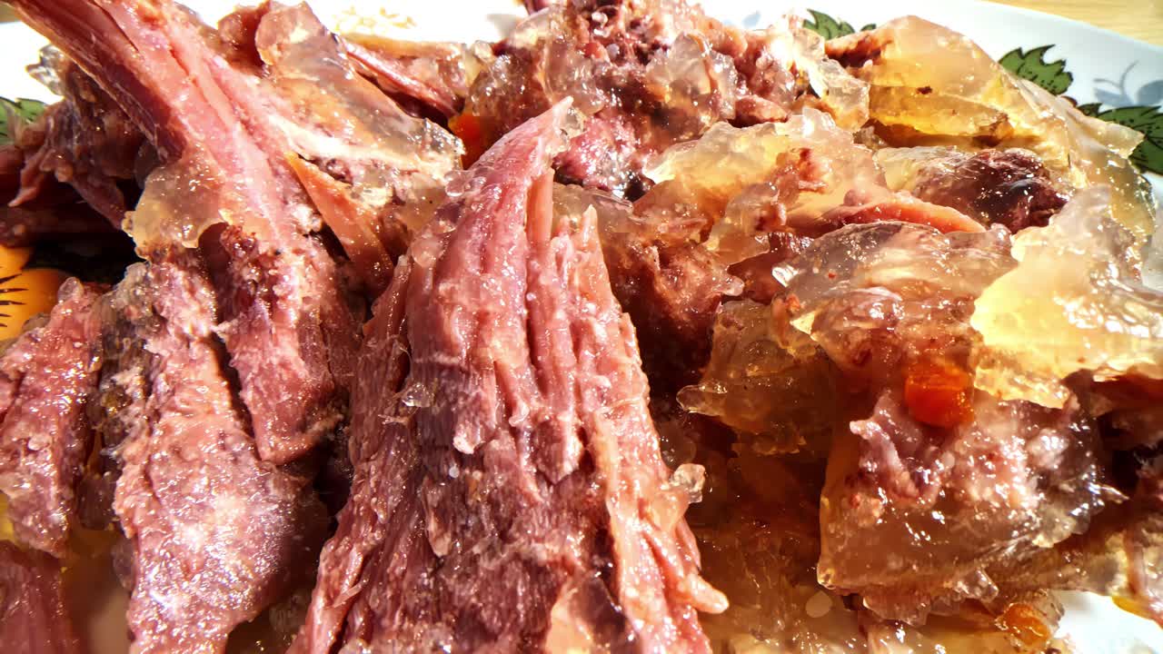 Dish with pork knuckle meat with gelatinous fat solidified before heating