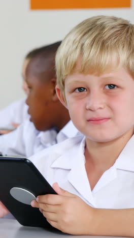 schoolkids using digital tablet in classroom