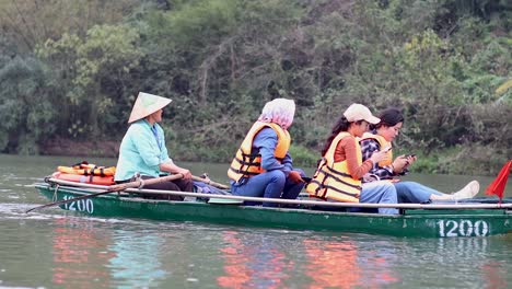 tourists on a boat ride in scenic ninh binh