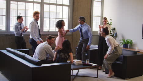 Female-boss-and-colleagues-celebrate-at-a-meeting,-close-up