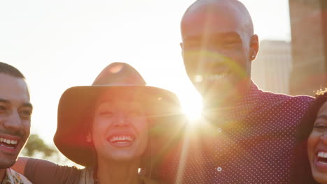 Portrait-Of-Friends-In-Front-Of-Manhattan-Skyline-At-Sunset