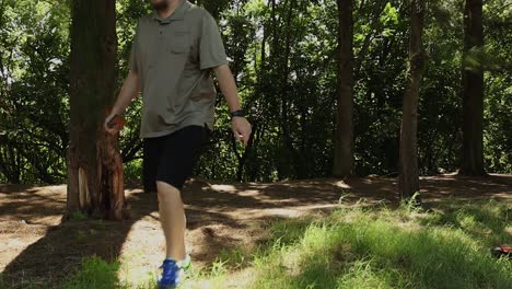 man alone walking through woods at an angle