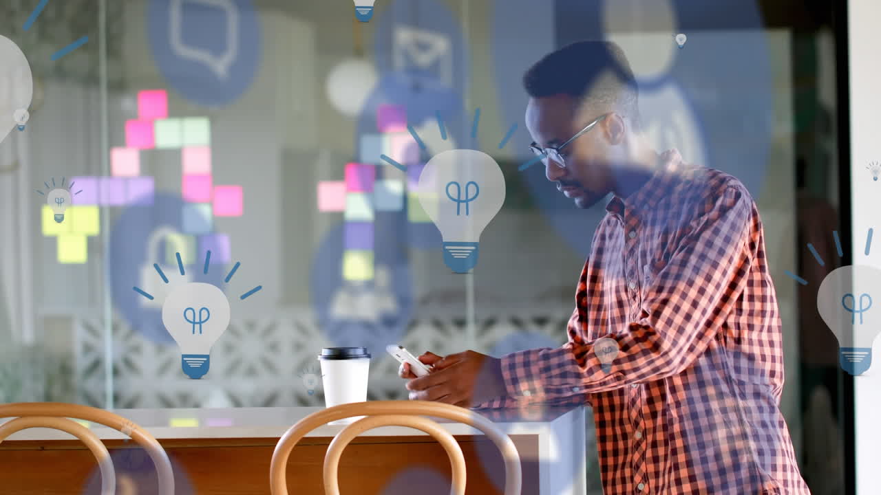 Animation of digital icons over man using smartphone