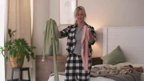 woman folding clothes in the bedroom