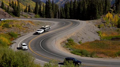 cars travelling on a curvy section of the million dollar highway in the san juan mountains of colorado