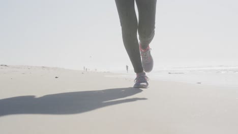 athletic woman running on the beach