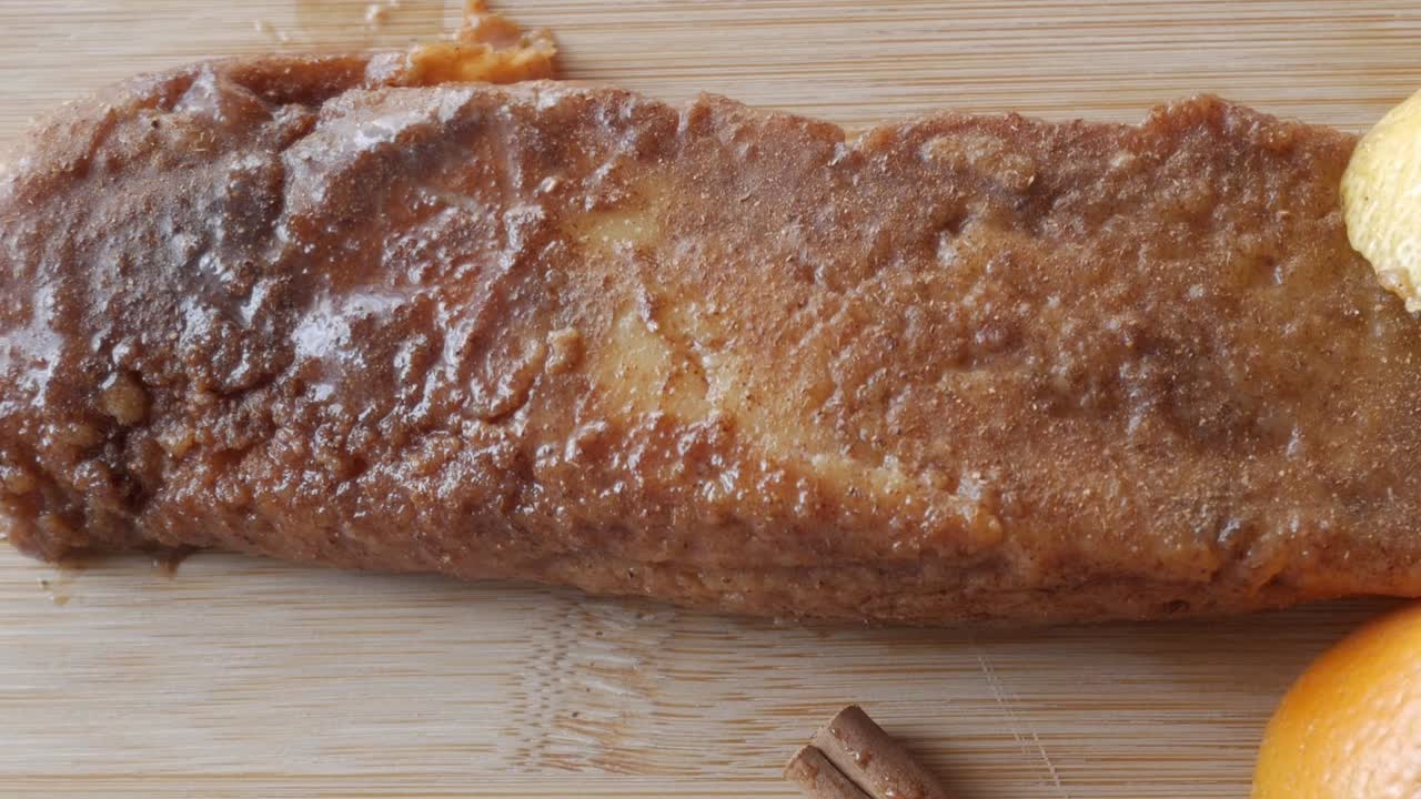 Torrijas dessert, a close-up of a sweet, golden slice on a wooden board