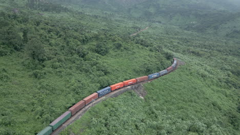 freight train travels around bend on the hai van pass in vietnam