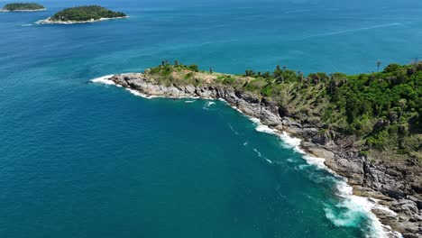 aerial view of a tropical cape with lush vegetation and azure waters