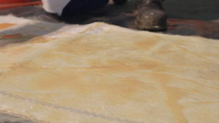 Spreading Industrial Glue With Squeegee