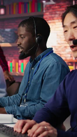 vertical video technical support specialist in call center office doing troubleshooting