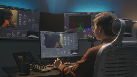video editor working on color grading in a modern editing suite