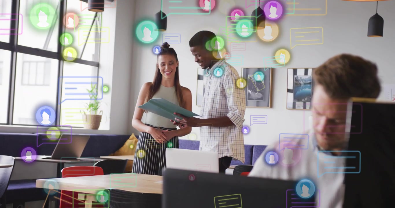 Man handing turquoise folder, woman reviewing documents for business, chat icons drifting over pair