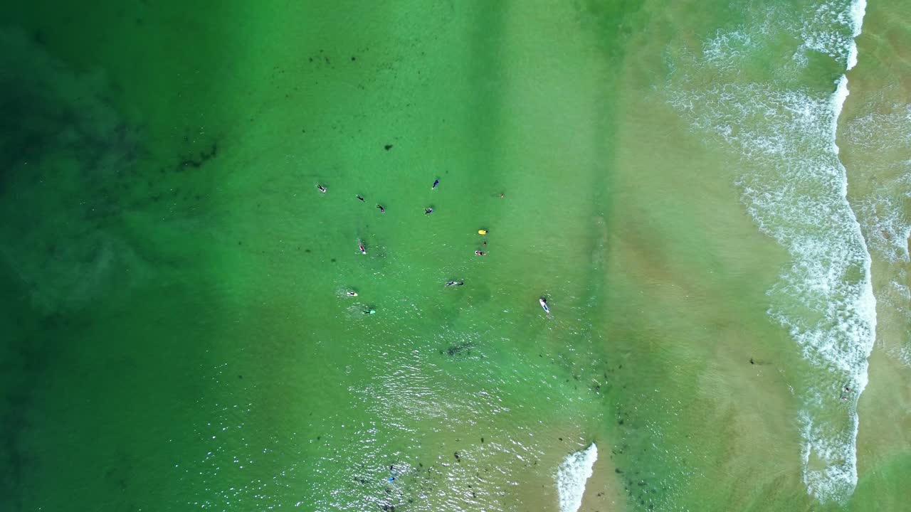Drone aerial bird's-eye shot Durras Depot beach people surfing bodyboarding sand bar ocean South Coast tourism travel Australia