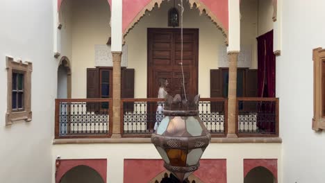 caucasian blonde tourist woman walking through moroccan riad rooms