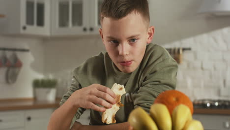boy eating a snack in the kitchen