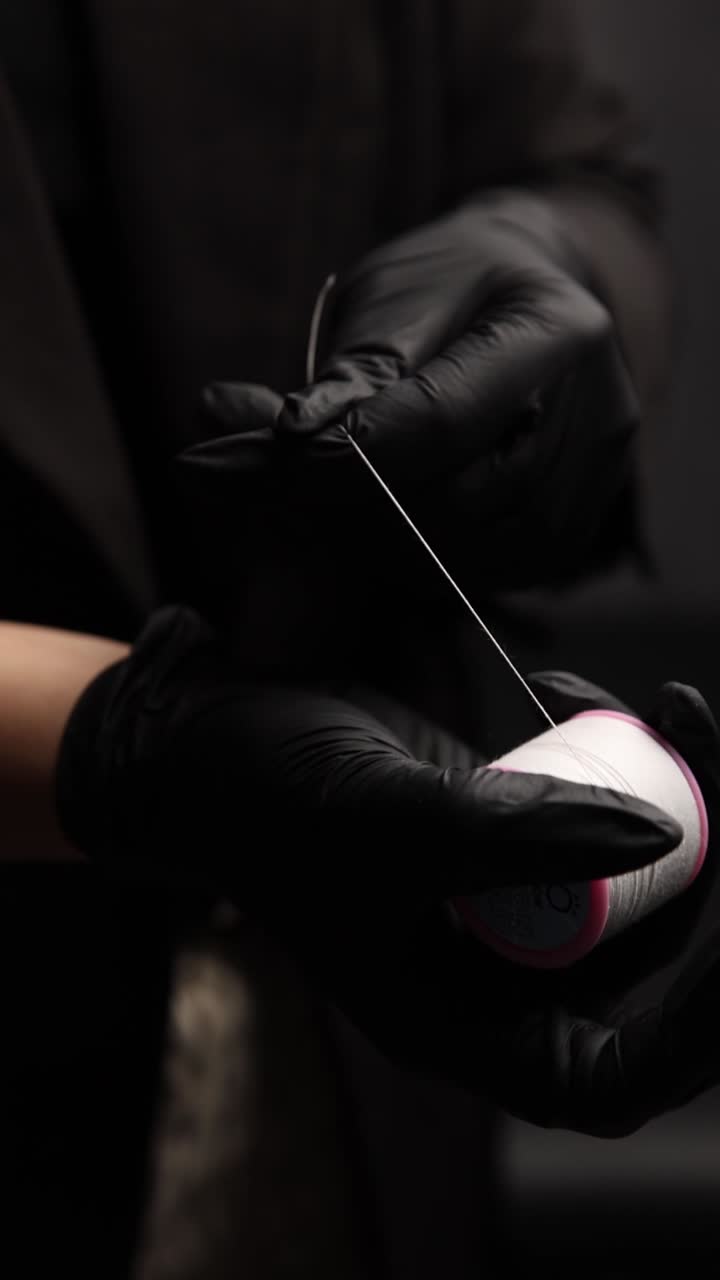 Hands holding thread