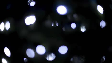 beautiful blue bokeh lights with a black background flickering