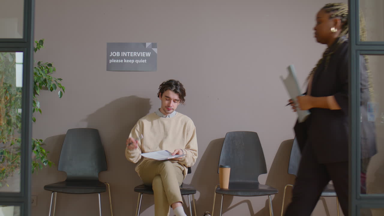 Young Man Drinking Coffee while Waiting for Job Interview