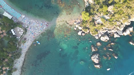 Top-Down-Drone-Flight-Over-Isola-Bella-in-Taormina,-Sicily,-Italy