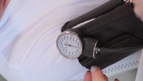 family doctor measuring the blood pressure of an elderly man.