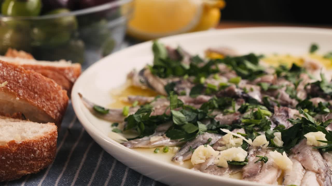Fresh Sea sardines and Anchovy Fish and Mullus On Display On Ice On Market Store Shop. Seafood Fish Background, close up stand of small salty white fish.