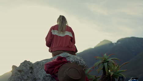 Woman,-mountain-and-sitting-on-rock