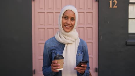 young woman wearing hijab out and about in the city