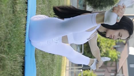 a brunette girl in a black top does stretching and neck exercises at home a brunette girl in a black top does stretching and neck exercises at home