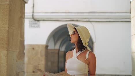 traveling woman reading map in city