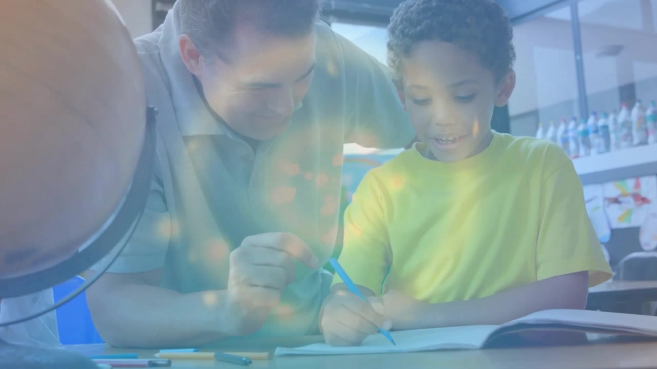 Boy gripping pencil while father guiding homework at desk pointing lines building confidence
