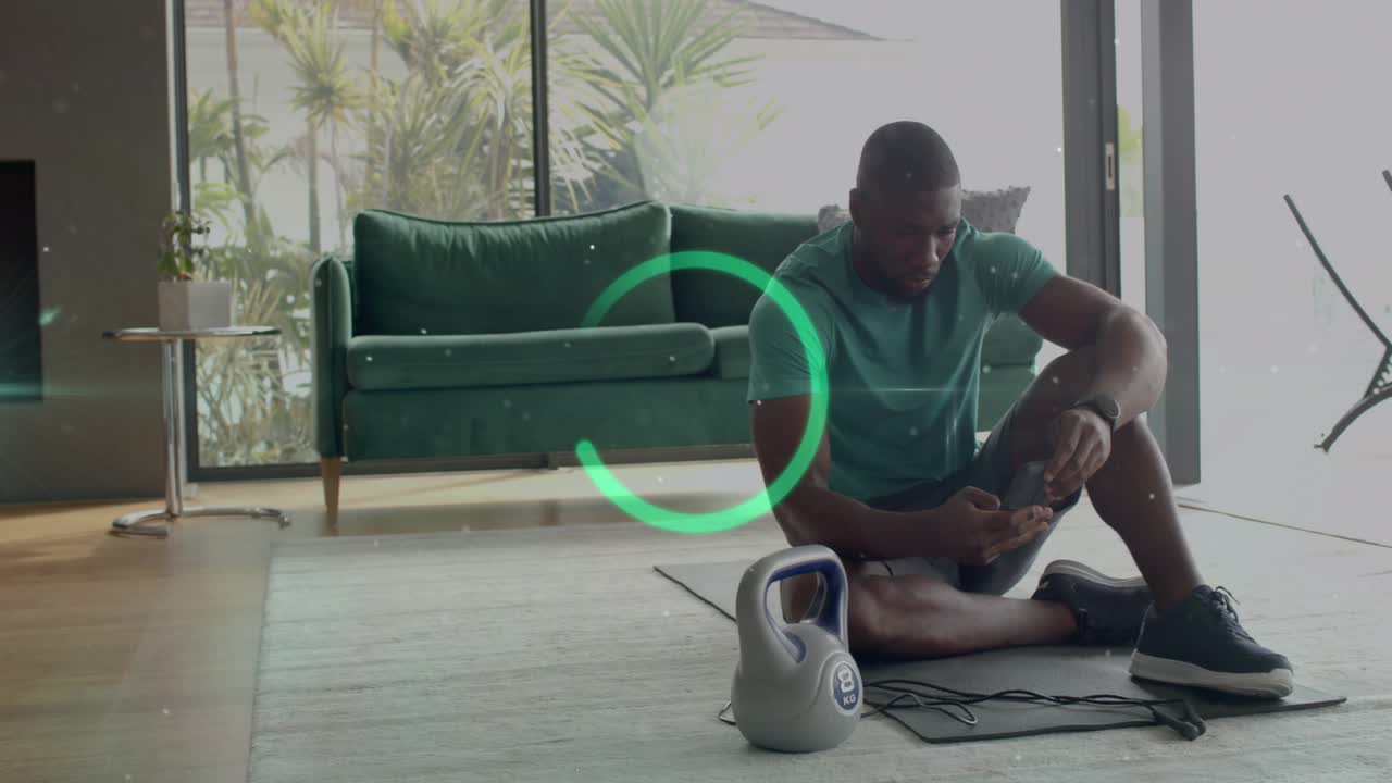 Man tapping smartphone, activating teal torso ring, checking watch, adjusting band for fitness