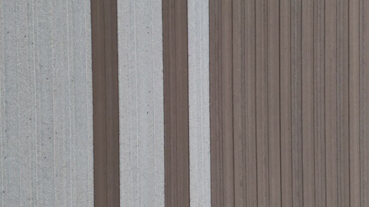 Top-down drone image shows a structured agricultural field with smoothed soil lanes, prepared using mechanized leveling techniques for upcoming soybean sowing in a precision farming context